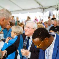 Don Lubbers shaking hands with a guest at the Jamie Hosford Football Center dedication.